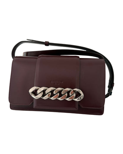 Brown handbag with a chain detail on a white background